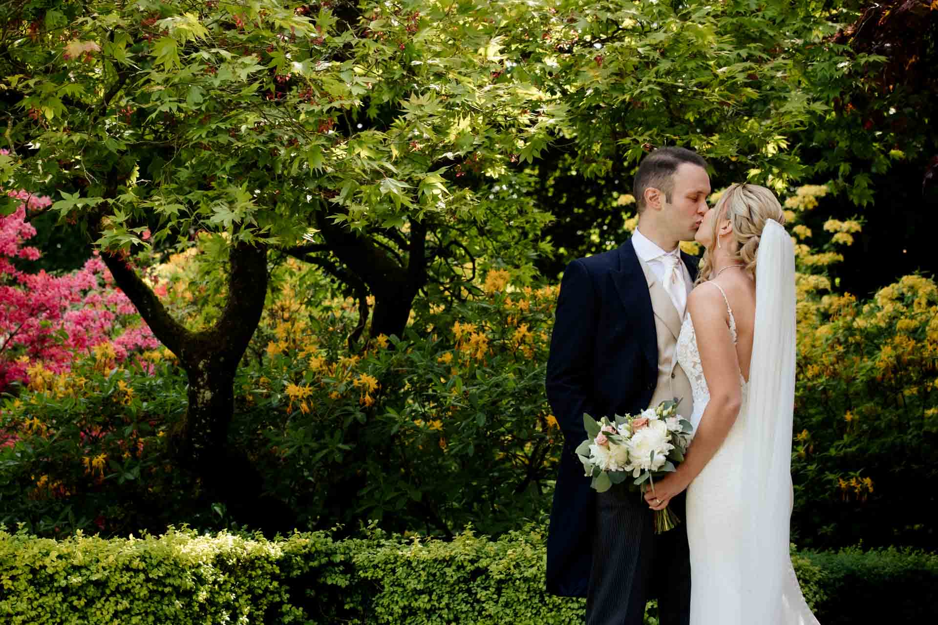 bride and groom portraits in the gardens at eaves hall lancashire